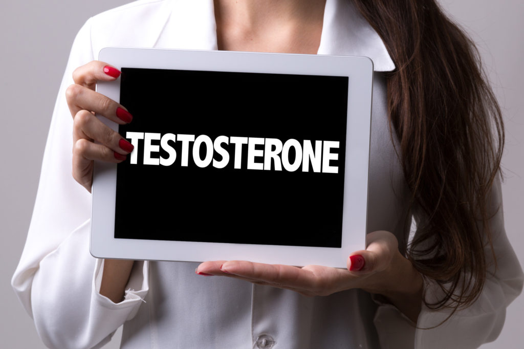 woman holding testosterone sign