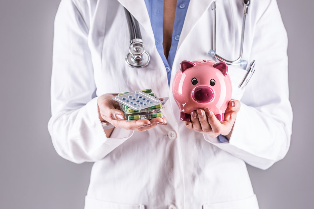 doctor holding a piggy bank